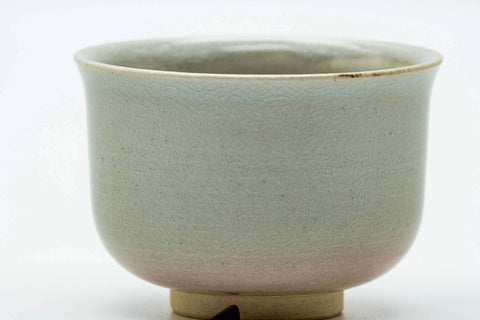 Close-up of the cup body showing the soft beige Hagi glaze above the exposed clay foot.