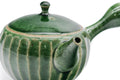 Green faceted Oribe Tokoname teapot, angled view showing the faceted body and handle