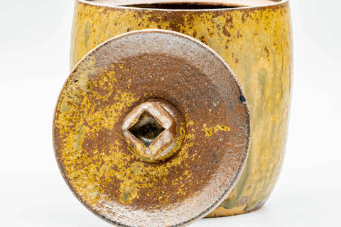 Underside and base view showing the unglazed foot and the lid's knob.