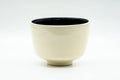 Side view of the chawan showing its smooth beige cylindrical outer wall