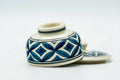 Low view of the teacup and its lid, lid off.