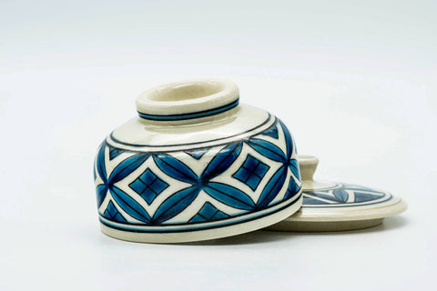 Low view of the teacup and its lid, lid off.