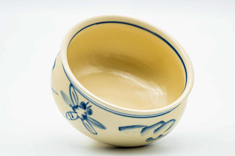 Three-quarter view looking into the kensui, revealing the smooth cream-glazed interior.