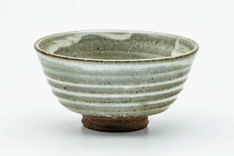 Side view of the spiraling chawan, showing the ridged grey-white glaze wrapping around the body.
