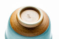 Underside of the cup showing the foot and an impressed stamp.