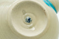 Underside of the turquoise Agano-yaki teapot showing the cream unglazed foot
