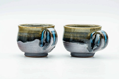 The pair from another angle, showing the drip glaze and side handles.