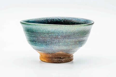 Slightly elevated front view showing the bowl's rounded form and streaked turquoise glaze.