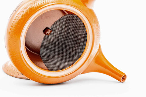 Interior view of the red shudei Tokoname kyusu showing the integrated clay mesh strainer wall