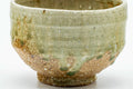 Side view of the Shigaraki chawan showing the green celadon glaze and earthy body