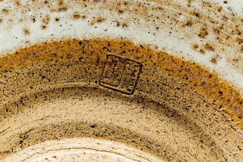 Closeup of the lower body and base of the chawan showing the brown clay and throwing rings