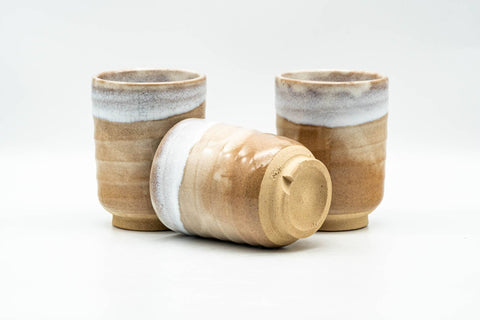 Three Hagi-yaki teacups at an angle, one lying on its side