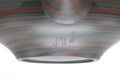 Close-up of the faceted nerikomi surface with reddish marbled bands.