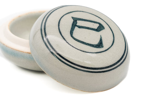 Close-up three-quarter view of the closed kogo, highlighting the hand-painted blue snake character and double-ring border.