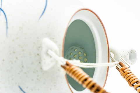 Japanese Dobin - Blue Floral White Textured Arita-yaki Porcelain Teapot - 500ml - interior view with the lid removed, showing the white interior and rattan handle