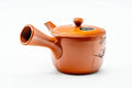 Angled view with the side handle at right and the spout to the lower left.