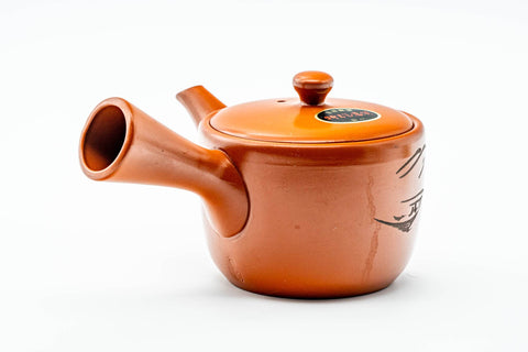 Angled view with the side handle at right and the spout to the lower left.