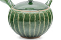 Green faceted Oribe Tokoname teapot, three-quarter view of the green Oribe glaze