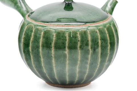 Green faceted Oribe Tokoname teapot, three-quarter view of the green Oribe glaze