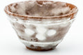 Close-up three-quarter view of a single cup, highlighting the milky white glaze.