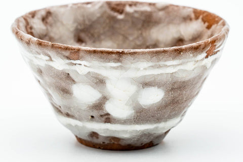Close-up three-quarter view of a single cup, highlighting the milky white glaze.