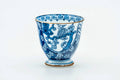 Side view of the teacup, showing the blue-and-white decoration.