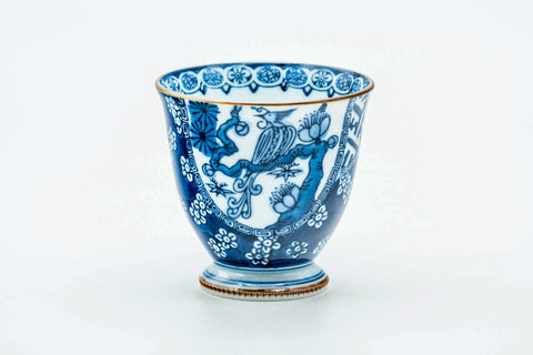 Side view of the teacup, showing the blue-and-white decoration.