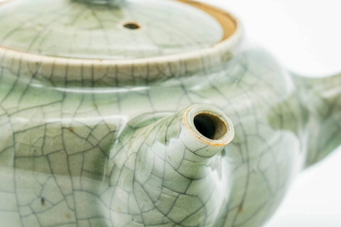 Closeup of the green celadon Obori Soma kyusu with lid on, showing the crackle glaze and spout