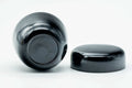 Small black-urushi ko-natsume matcha caddy, three-quarter overhead view with lid off, showing the interior rim and lid underside