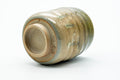 The cup tipped to show its unglazed foot and base.