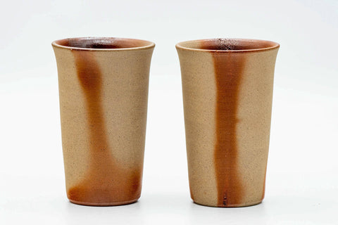 The pair of tall orange cups viewed from a slightly different angle.