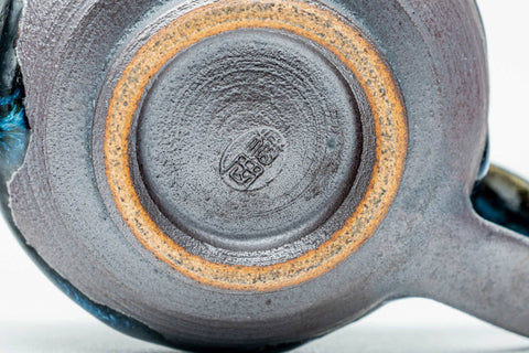 Underside of a cup, showing the foot.