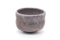 Mino-yaki chawan, front view showing the earthy brown body with cloudy pale glaze patches
