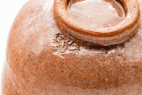 Close-up of the body and foot showing glaze texture and the carved foot ring.