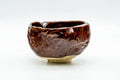 Opposite three-quarter view of the dark burgundy glazed pouring bowl