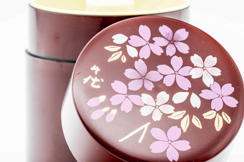 Close-up of the lid showing the pink and purple sakura-blossom design