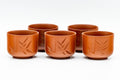 The five matching yunomi teacups grouped together, each with the engraved bamboo motif.