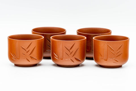 The five matching yunomi teacups grouped together, each with the engraved bamboo motif.