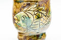 Close-up of the engraved fish decoration on the cup's body.