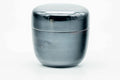 Small black-urushi ko-natsume matcha caddy, lid on, side view of the glossy domed lid