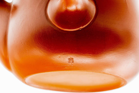 Close-up of the glossy red body where the lid meets the rim.