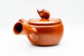 Profile view showing the straight side handle and pouring spout.