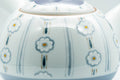 Close-up of the teapot spout base and painted blue motifs