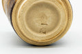 Underside of a cup, showing the unglazed foot.
