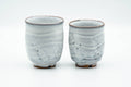 Tezumi — Japanese Teacups - Pair of Milky White Glazed Wavy Meoto Yunomi — front view