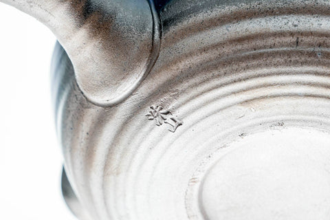 Close-up of the body showing the layered blue-grey glaze drips above the foot.