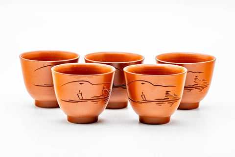 The five matching red shudei guinomi cups grouped together on a white background.