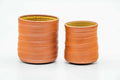 The pair of teacups from another angle, showing the size difference between the two cups.