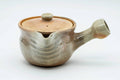 Beige weathered Hagi-yaki kyusu, raised three-quarter view showing the lid knob and side handle