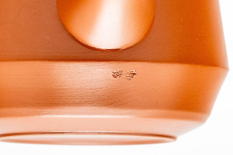 Close-up of the teapot body showing the engraved bamboo decoration and foot.
